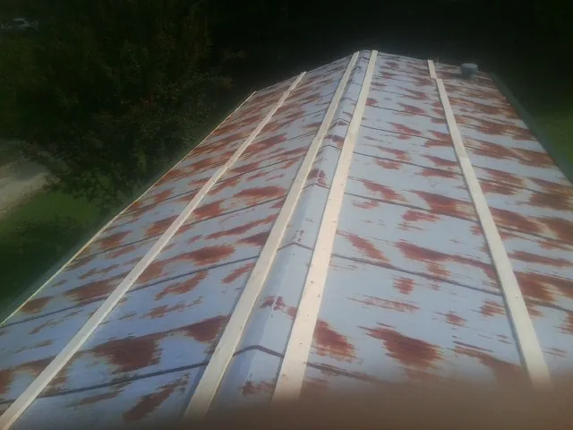 Rusted metal roof panels with new wood purlins before replacement — Storm Damage Roof Repair in Bucoda by Roofing Brothers