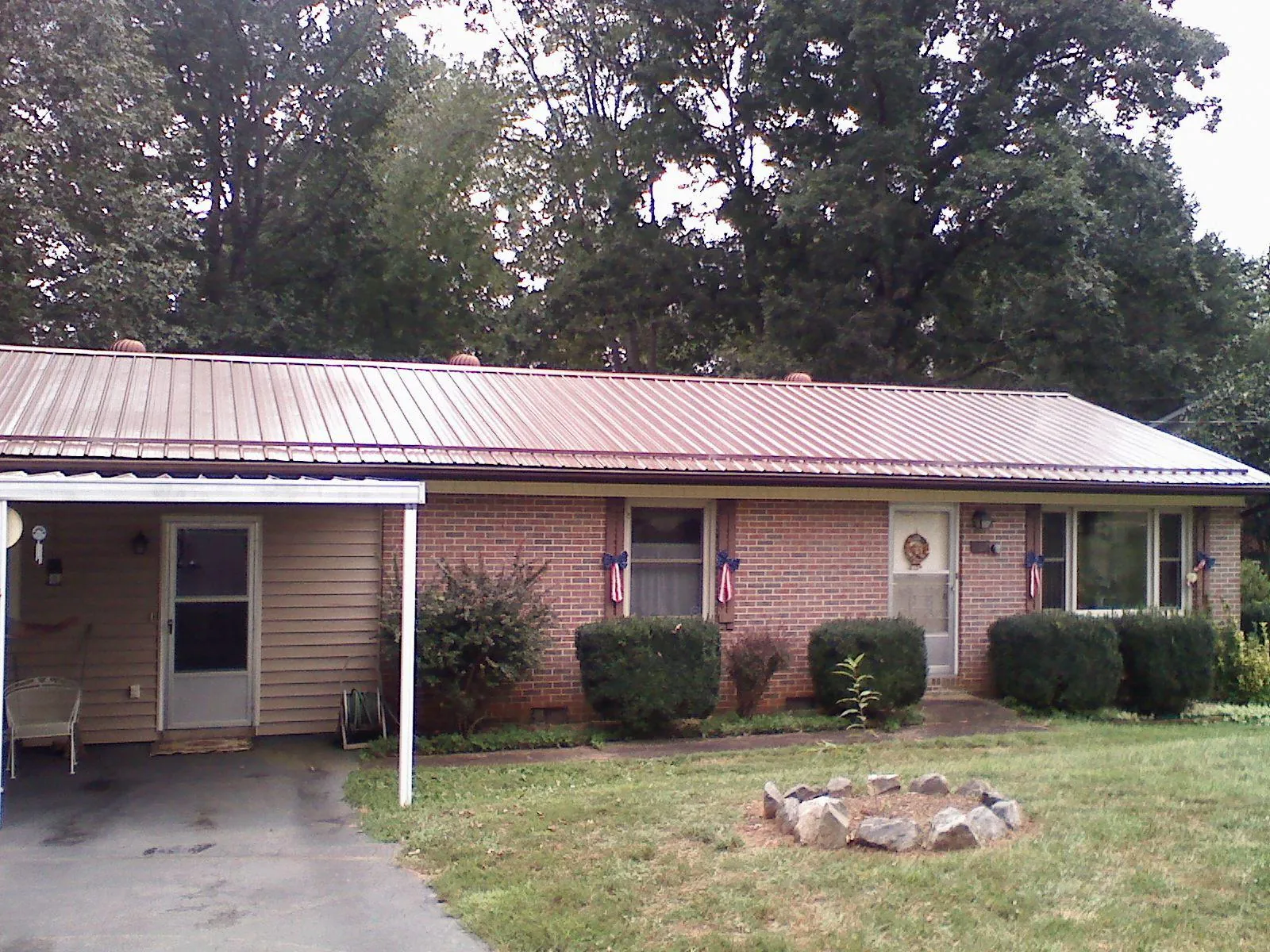 Bronze metal roof and carport on a brick ranch home — Roof Repair work by our crew in Bucoda